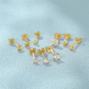 Detailed view of S925 sterling silver gold-plated stud earrings with star and floral designs