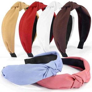 Set of six colorful knotted fabric headbands in assorted pastel and earthy tones