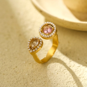 Detailed close-up of a gold double-gemstone ring with pink and clear jewels set in pearls