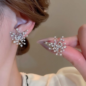 Elegant silver snowflake stud earrings with white pearls and sparkling cubic zirconia