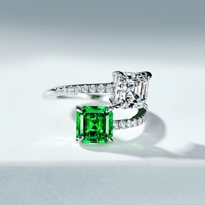 Macro detail of adjustable ring featuring square green and clear cubic zirconia stones