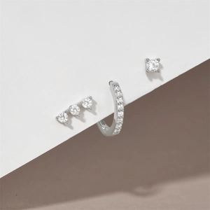 Detailed macro of S925 sterling silver three-piece earring set with turquoise and clear zircon