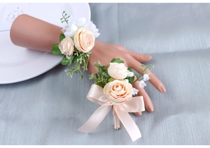 Detail of champagne artificial rose corsage and wrist flower set for wedding events