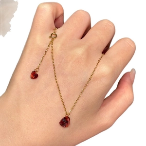 Minimalist gold necklace featuring two sparkling red heart pendants for women
