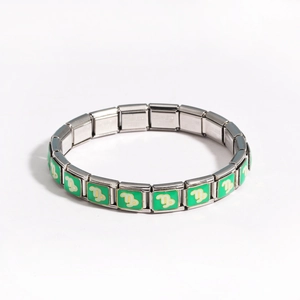 Detail of Italian modular stainless steel charm link with green enamel and Capricorn symbol