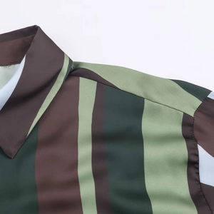 Detail of green and brown vertical striped satin shirt showing shoulder seam and collar texture