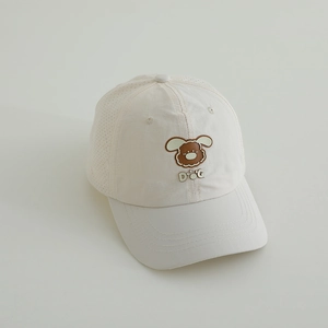 Detail of breathable laser-cut vents and cartoon dog patch on kids dry-fit sun cap