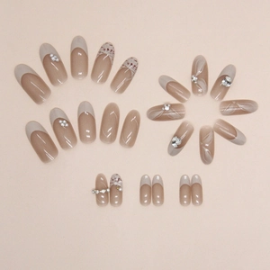 Elegant oval press-on nails with plaid pattern, pearls, and rhinestones in nude pink
