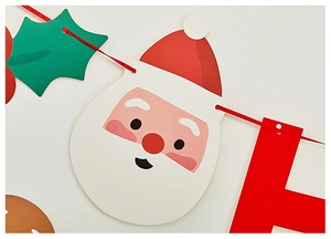 Detail of Christmas banner featuring Santa Claus, holly leaves, and red festive letters