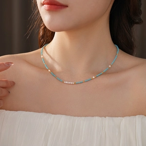 Titanium steel necklace with turquoise beads and freshwater pearls on female model