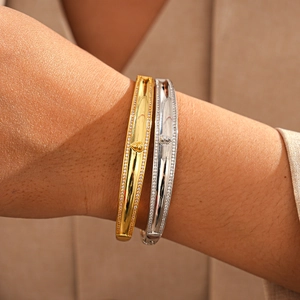 Detail of 18k gold and silver plated bangles with fine zircon pavé set edges