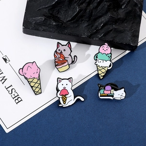 Detailed set of five cartoon cat and ice cream enamel pins on a white greeting card
