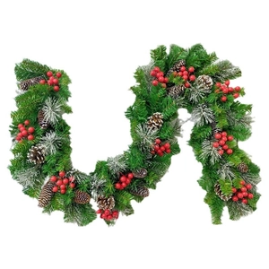 Christmas pine needle garland with red berries and snowy pinecones on white background