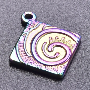 Macro shot of square stainless steel pendant with rainbow PVD coating and spiral engraving