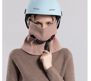 Pink fleece balaclava mask for skiing with ponytail hole shown under a blue helmet