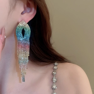 Detail of colorful gradient tassel earrings with rhinestones on female model