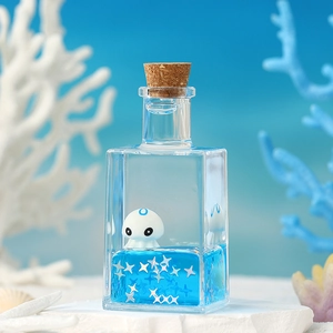 Ocean drifting bottle desk ornament with floating octopus and blue liquid sea theme