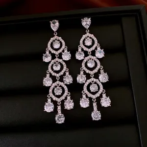 Luxurious vintage-style silver hoop earrings with tiered zircon tassels on black texture
