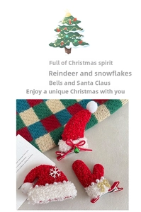 Detail of knitted Christmas hair clips featuring festive hat, glove and bell designs