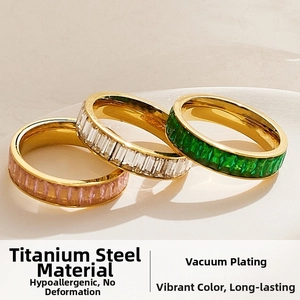 Macro shot of three stacked stainless steel eternity rings with colorful zircon stones