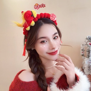 Detail of red festive headband featuring plush lion dance elements and lucky tassels