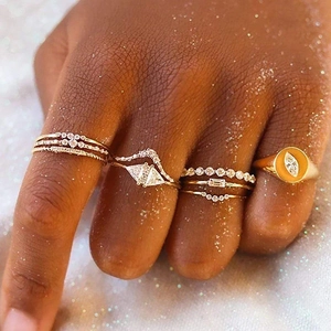 Close-up of S925 sterling silver rings with turquoise and pearls on hand in warm light