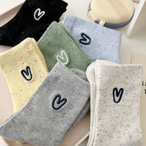 Colorful cotton blend socks with heart embroidery in various colors stacked neatly