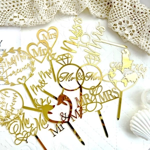 Golden acrylic wedding cake toppers with Mr and Mrs lettering for romantic decor
