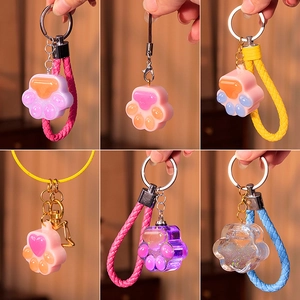 Cat paw resin keychain mold set with heart patterns and colorful braided straps