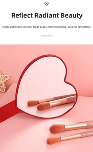 Close-up of red heart-shaped handheld makeup mirror with high-definition glass and handle