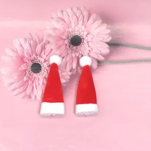 Gros plan de mini bonnets de Noël en peluche rouge pour poupées et décors de fête
