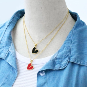 Detail view of heart pendants with beaded edges in red and black enamel finish