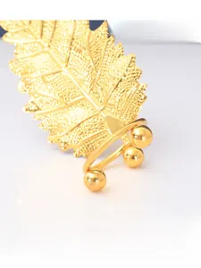 Macro detail of Nordic golden metal leaf ornament with iron welding and electroplated finish