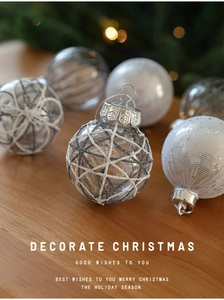 Detailed view of 6cm silver glitter and white textured Christmas ornaments with silver loops