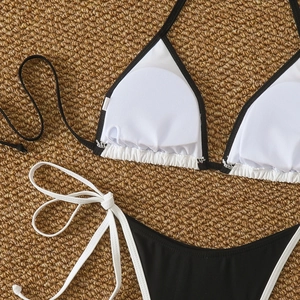 Detail of black and white bikini top showing removable padding and dual-color straps