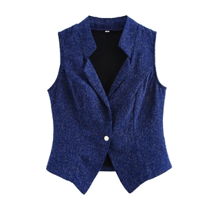 Detailed close-up of dark blue sleeveless vest with textured fabric and white button