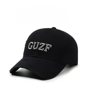 Detail of vintage black baseball cap with rhinestone GUZF letters and distressed brim