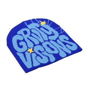 Detailed macro shot of blue knit beanie featuring Grail Visions jacquard text and stars