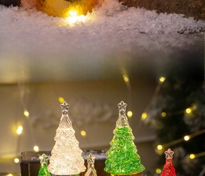 Close-up of LED glowing crystal Christmas tree ornament with festive bokeh background