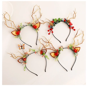 Close-up of assorted Christmas reindeer antler headbands with pine cones and red berries