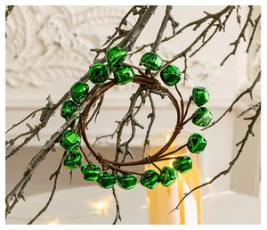 Close-up of artificial bell wreath with green metal bells on rustic brown vine base