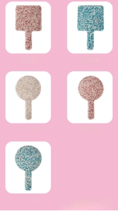 Macro detail of rhinestone embellished handheld makeup mirror in sparkling pink finish
