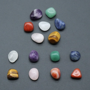 Set of 14 irregular natural crystal stones for yoga chakra healing on gray background
