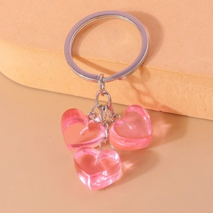 Close-up of translucent pink heart charms on a silver metal keychain accessory