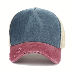 Detail of washed denim baseball cap featuring pink distressed brim and breathable mesh