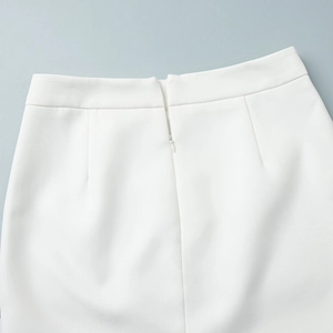 Detail shot of white skirt waist featuring invisible zipper and tailored darts