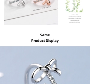 Detail of silver and rose gold bow-shaped rings featuring sparkling embedded crystals