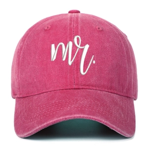Close-up of pink washed cotton baseball cap featuring white Mr. embroidered cursive text
