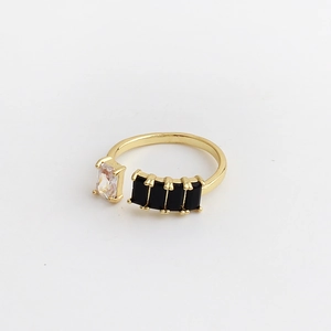 Detail of adjustable gold ring with rectangular transparent and black zircon stones