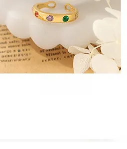 Macro detail of 18K gold-plated adjustable ring featuring colorful round gemstones